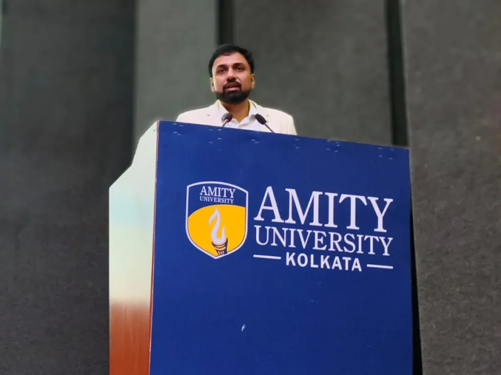 Dr. Sabyasachi Saha speaking from the Amity University Kolkata podium on the future scope of AI and full stack
