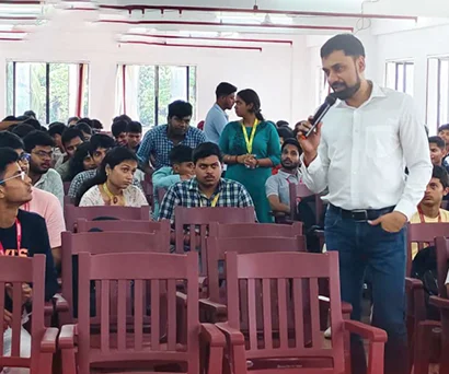 Dr. Sabyasachi Saha walking among students during the Brainware University seminar